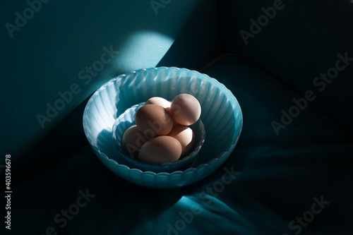 Eggs in the shadow in a blue bowl