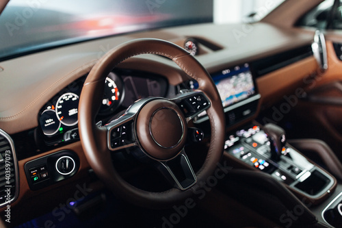 Expensive suv car interior with the steering wheel, multimedia dashboard, and gearbox handle © Moose