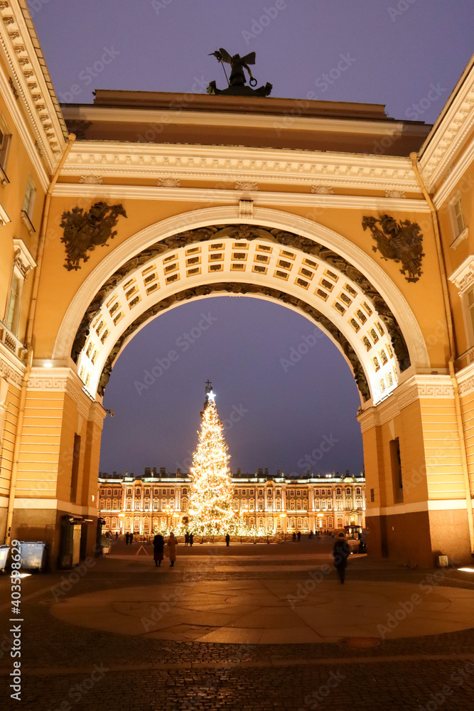 New year and christmas decoration with tall and beautiful fir tree on the Palace square of Saint Petersburg in Russia view through the arch