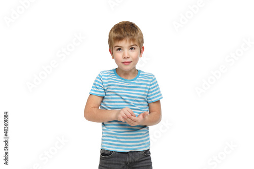 Little cute boy in striped clothes pretends to write something down isolated on white background.