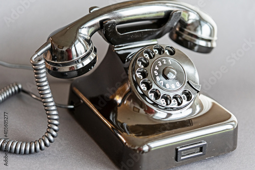 An old black telephone from the 50s with dial