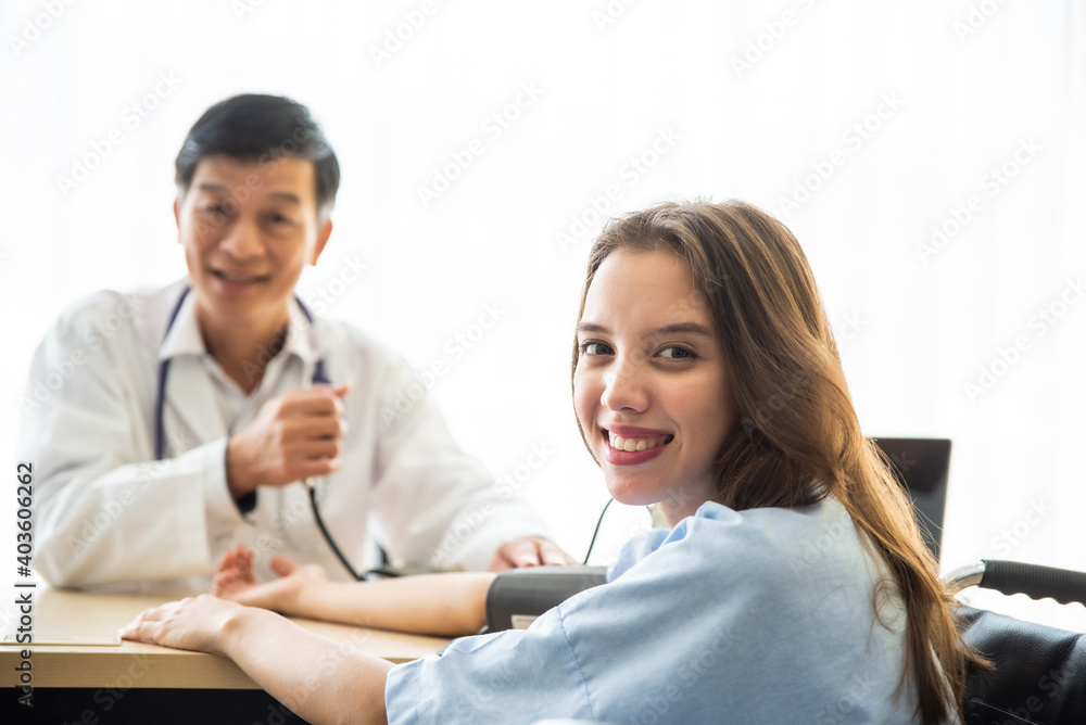 Doctor Checking Blood Pressure Of Patient At Medical Clinic Doctor Checking Blood Pressure Of Patient At Medical Clinic