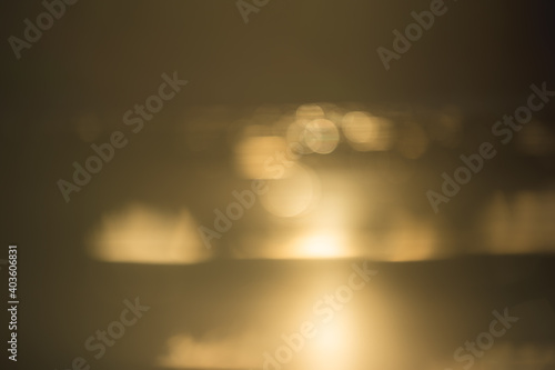abstract blurry background if golden water surface at sunset