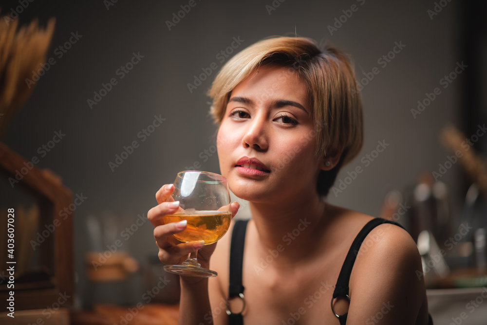 Attractive bartender girl holding in her hands fresh cocktail at the bar counter for celebration Attractive bartender girl holding in her hands fresh cocktail at the bar counter for celebration
