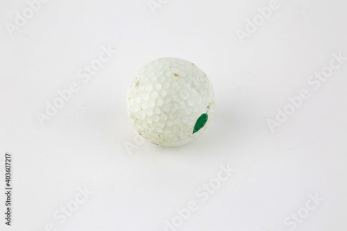 old golf ball as sport equipment isolated in white