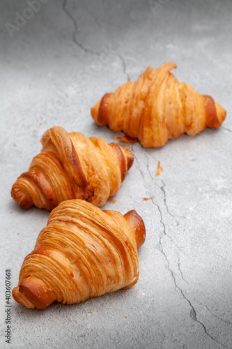 Fresh baked croissants on cement background.