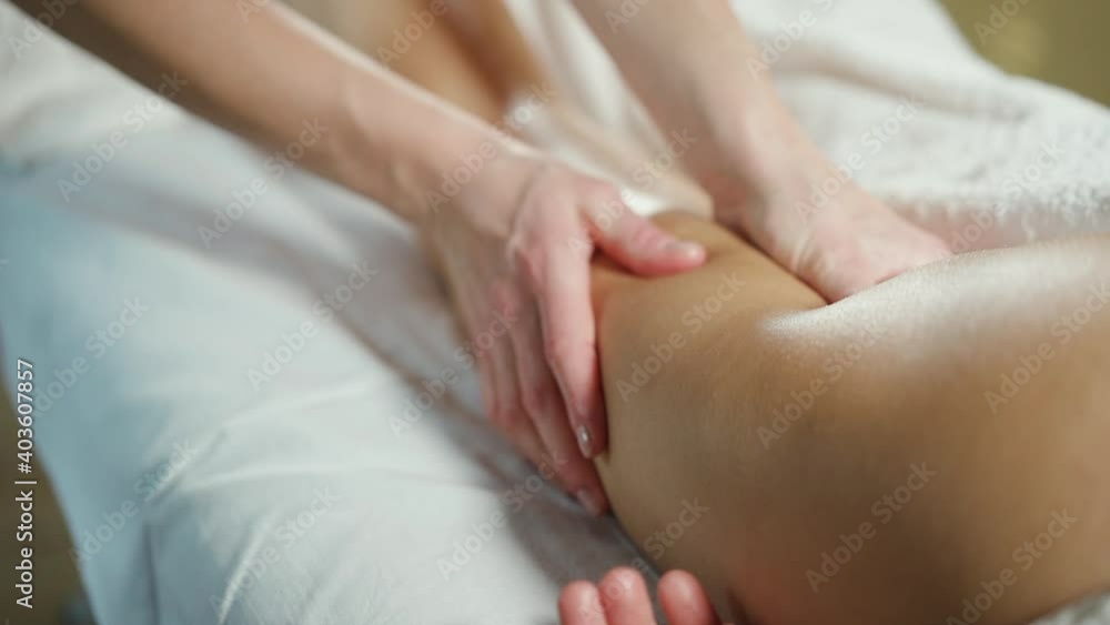 Close-up female hands doing massage of the thigh. Woman modeling massage. Close-up female hands doing massage of the thigh. Woman modeling massage.
