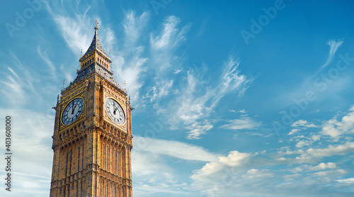 Big Ben Clock Tower in London, UK, on a bright day. Panoramic composition withcopy-space, text space on blue sky with feather clouds.