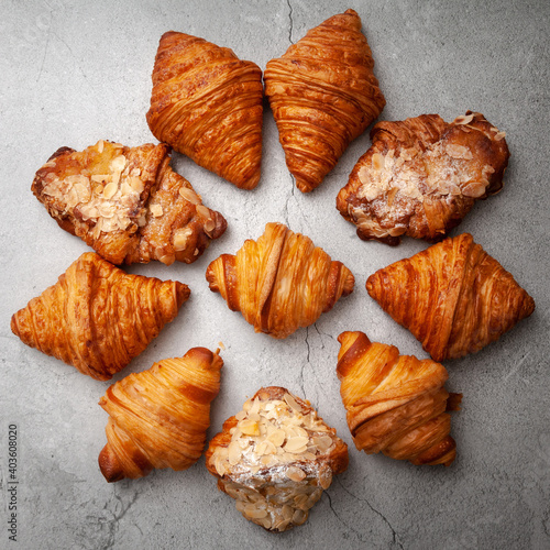 Fresh baked croissants on cement background.