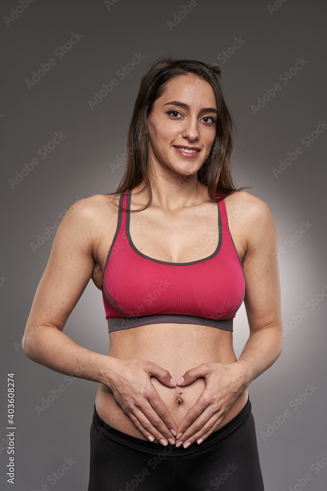 Active pregnant woman on gray Active pregnant woman on gray