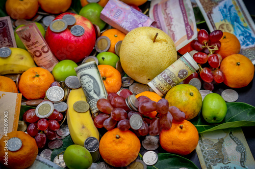 Fototapeta Naklejka Na Ścianę i Meble -  Money rains on fruits and vegetables