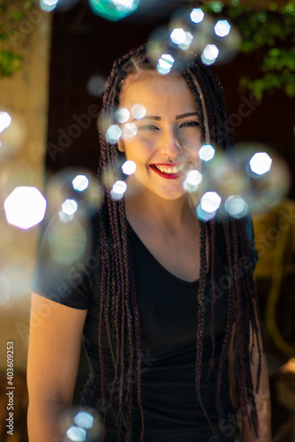 Happy girl, beautiful happy girl and soap bubbles with natural light, selective focus.