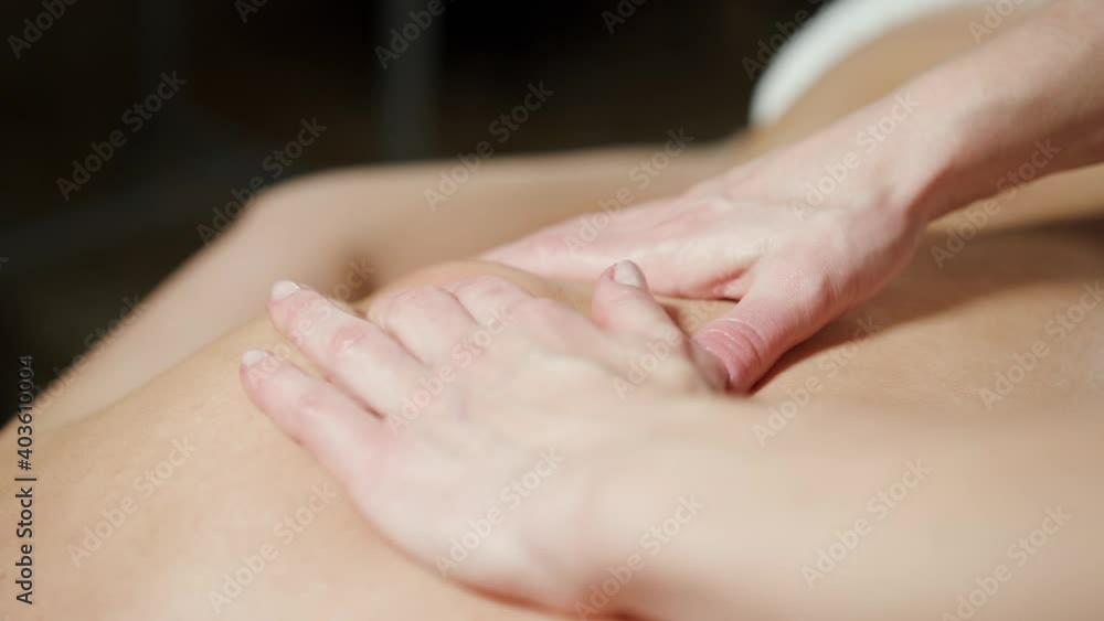 Close-up massage in the back area with two hands. Close-up massage in the back area with two hands.
