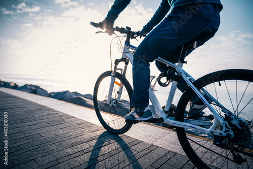 Cyclist riding bike in the sunrise coast path © lzf