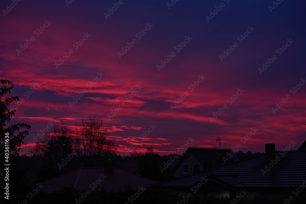 red sunrise over country houses