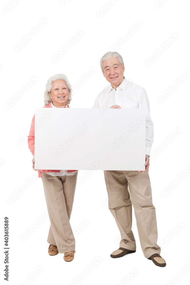 An old senior couple holding white board 