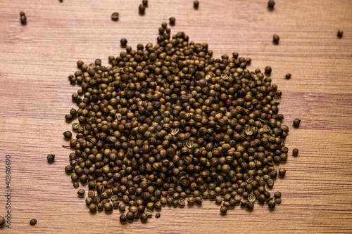 Seed coriander on a wooden background. View from above. Seasonings for meat and tea..