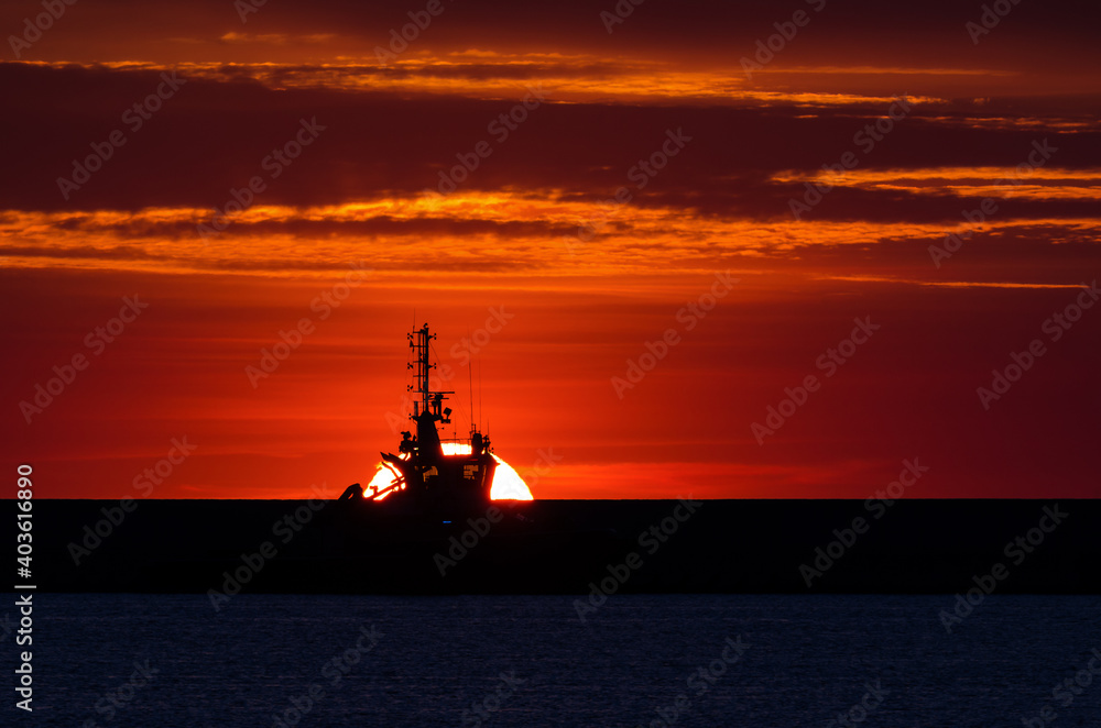 FIREABOAT - A rescue boat against the backdrop of a fiery sun
