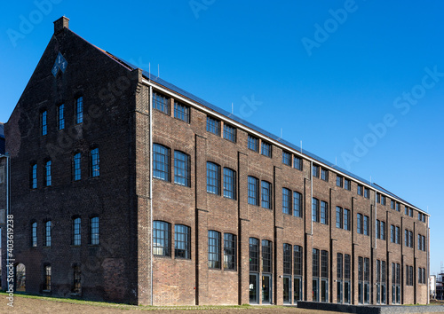 Dark brick facade of an old abandoned factory.