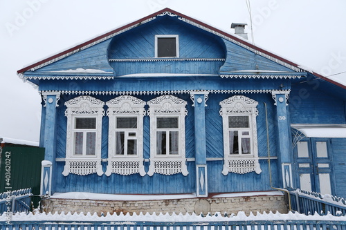 Vintage wooden rural house in Dunilovo village in Ivanovo region, Russia. Building facade; ornamental windows with carved frames. Russian traditional national folk style in architecture. Countryside photo