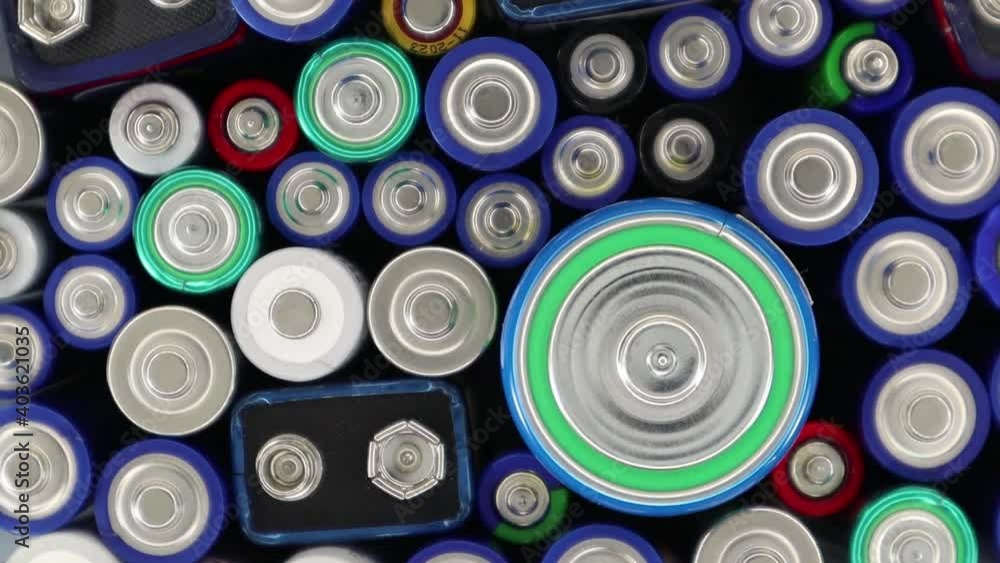 Close-up of used alkaline batteries of different types and grades. Many used batteries rotate. The harmful effects of batteries on the nature of the planet Earth and disposal Close-up of used alkaline batteries of different types and grades. Many used batteries rotate. The harmful effects of batteries on the nature of the planet Earth and disposal