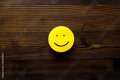Smiling face emotion concept. Smile face on paper banner, top view