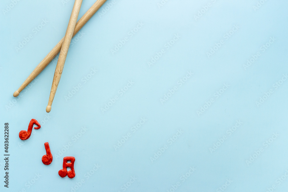 Drum sticks with music notes, overhead view. Music background Drum sticks with music notes, overhead view. Music background
