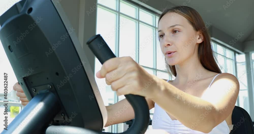 Healthy Lifestyle and Sport Concepts. Attractive young woman training on bike at the gym. Healthy Lifestyle and Sport Concepts. Attractive young woman training on bike at the gym.