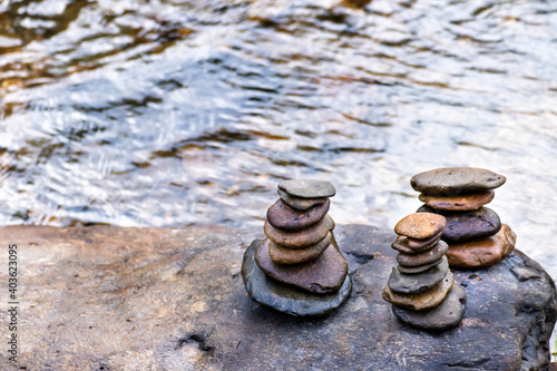 Photography Balanced Zen rock stacks in a creek,View of a creek with stacked stones on a roc