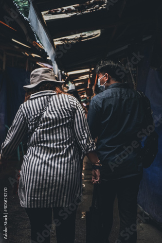 Two people strolling in a market