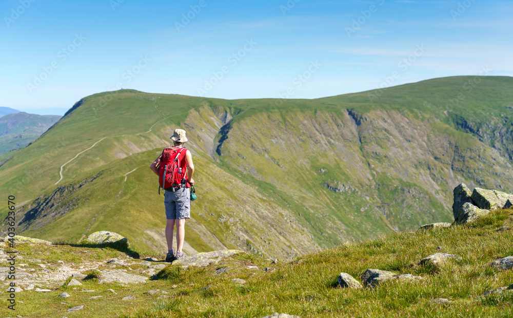 A female hiker taking in the views of Froswick and Thornthwaite