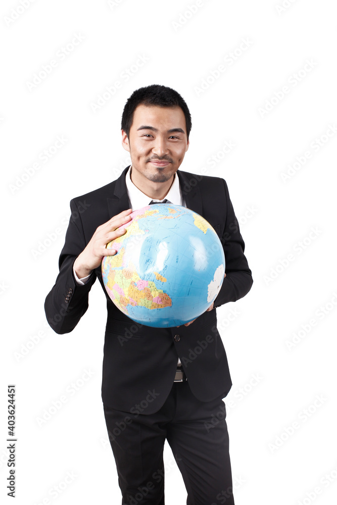 A young business man holding terrestrial globe A young business man holding terrestrial globe