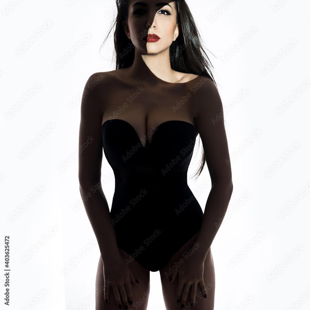 Naklejka premium Fashion art studio portrait of elegant woman in stripes of shadows. Professional makeup . Stylish lingerie