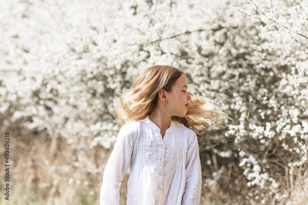Young brunette girl in white blossom outdoor. Woman spring portrait with copy space Young brunette girl in white blossom outdoor. Woman spring portrait with copy space