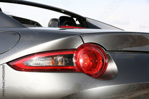 Close-up car rear tail-lamp with a brakelight stop signal.