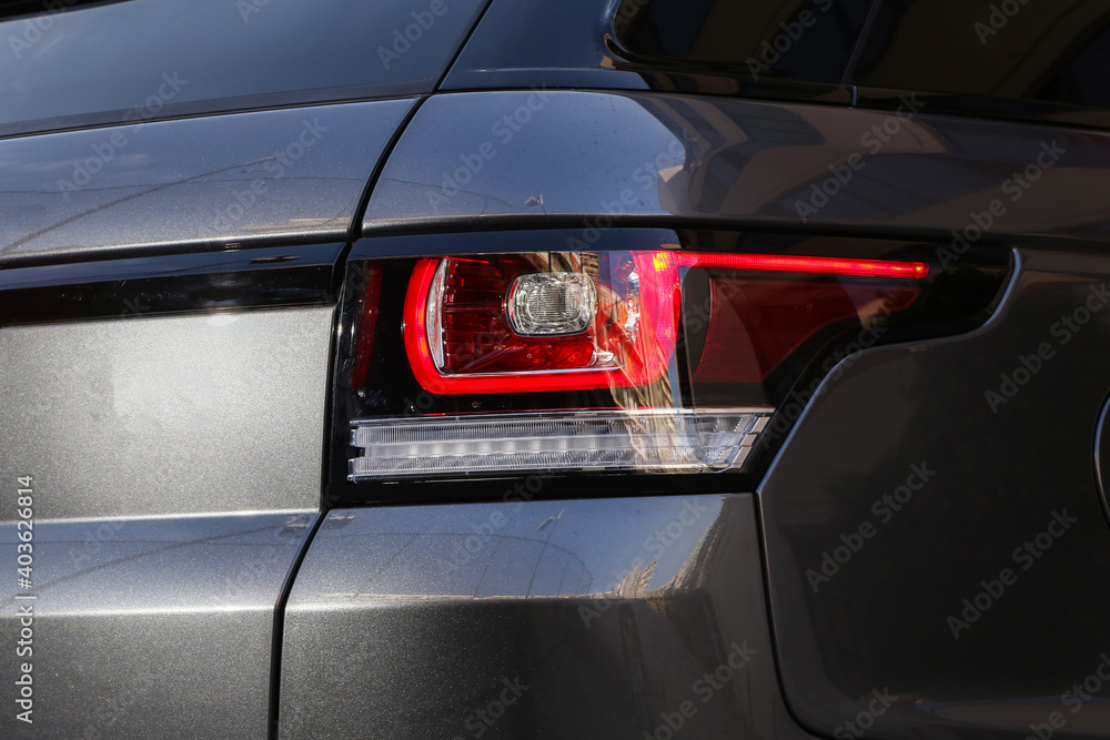 Close-up car rear tail-lamp with a brakelight stop signal. Close-up car rear tail-lamp with a brakelight stop signal.