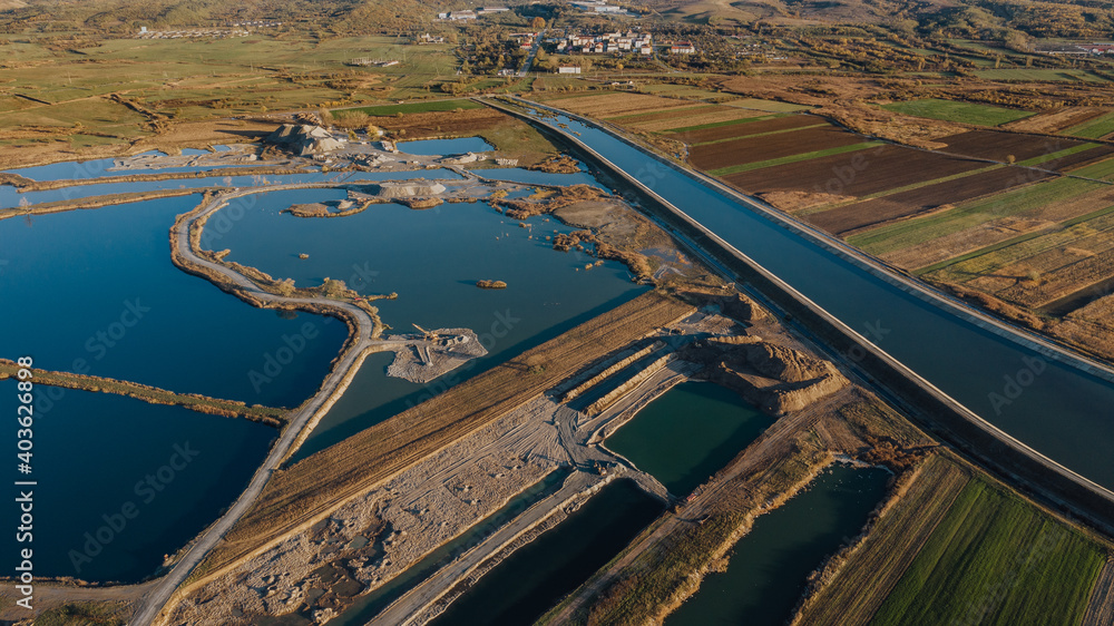 Aerial view on open pit mine of sand, hummus and coal, flooded with water