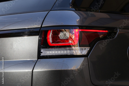 Close-up car rear tail-lamp with a brakelight stop signal.