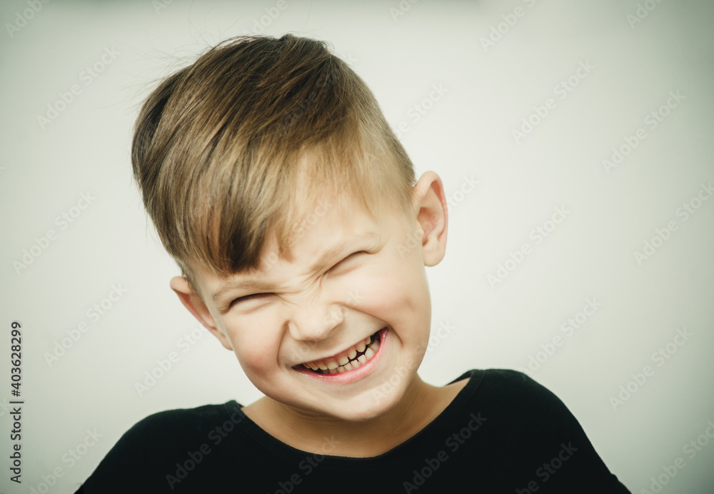 portrait of a sly boy on a white background