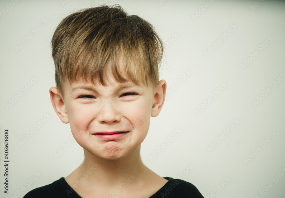 portrait of a crying offended boy on a light background portrait of a crying offended boy on a light background
