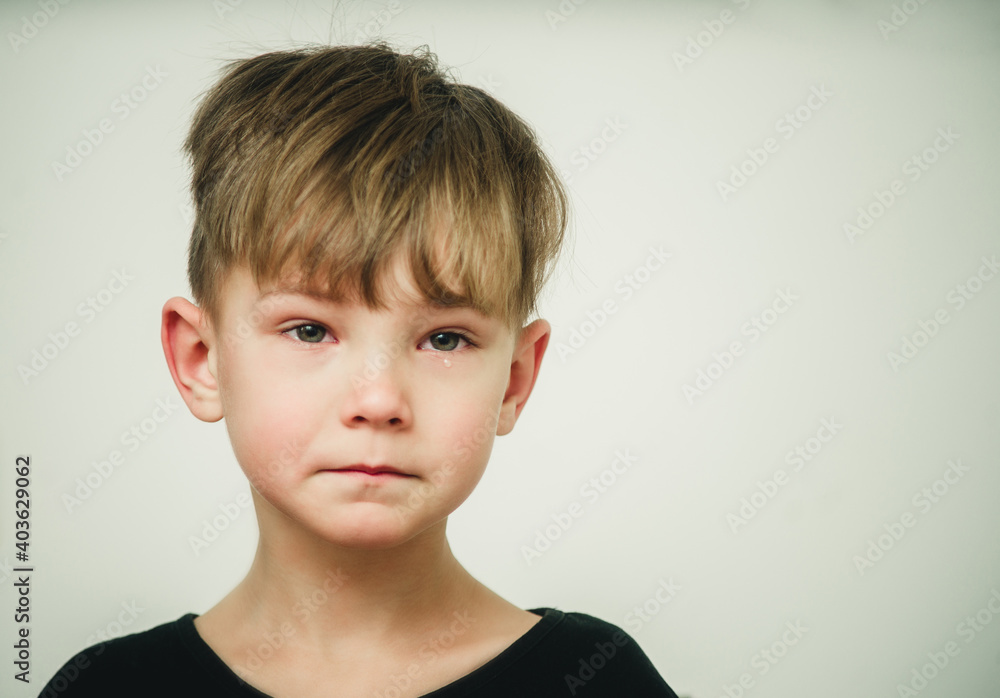portrait of an offended and crying boy close-up portrait of an offended and crying boy close-up