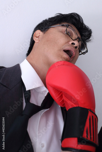 Business man getting punch with boxing glove. © sittinan