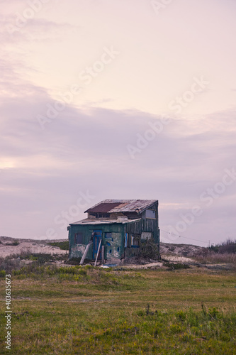 Rancho o casa humilde de chapa en la playa, costa uruguaya Cabo polonio. photo