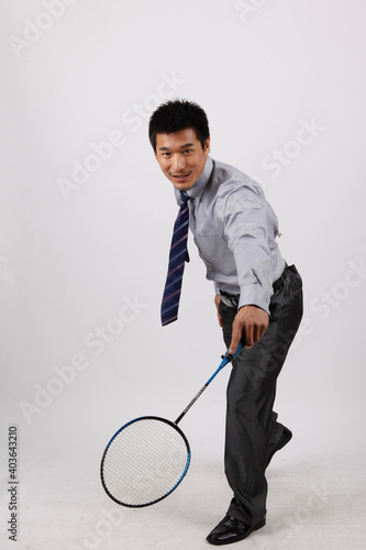 A business exercising with man playing badminton