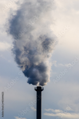 chimney with smoke by the river pollute global warming