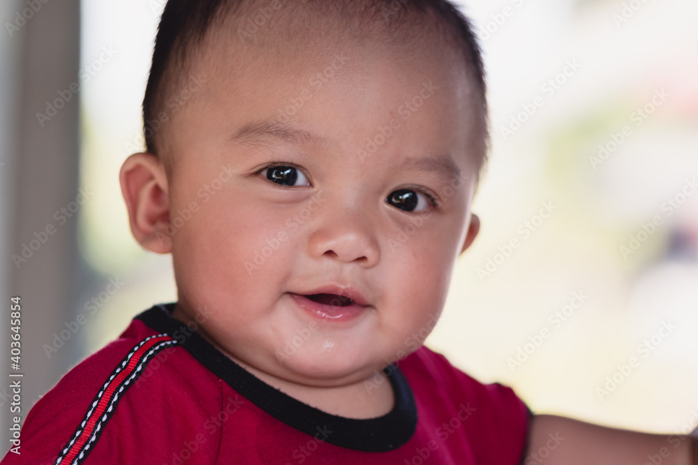 Portrait of adorable expressions of Asian little baby on nature background and day light with copy space,Cute boy, 7 months old, crawling age, good smile and good mood. Healthy, big black eyes. Portrait of adorable expressions of Asian little baby on nature background and day light with copy space,Cute boy, 7 months old, crawling age, good smile and good mood. Healthy, big black eyes.