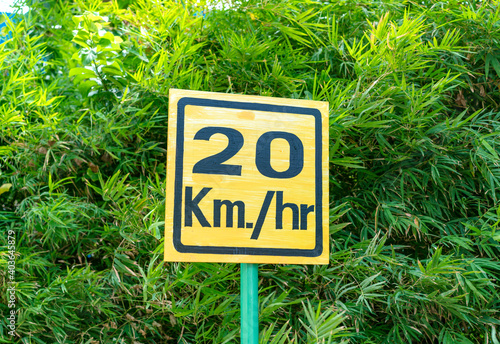 Speed limit sign on a background of green trees photo