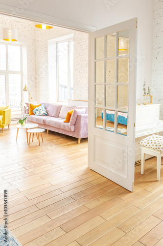 very light and sparcious two-rooms apartment in scandinavian design style with fashion furniture and large windows. warm colors during day time