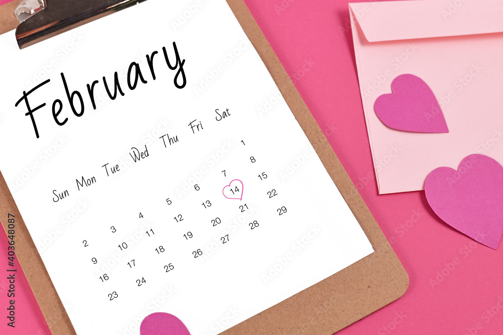 February calendar sheet with Valentine's Day on the 14th marked with heart surrounded by hearts and love letter on pink background February calendar sheet with Valentine's Day on the 14th marked with heart surrounded by hearts and love letter on pink background
