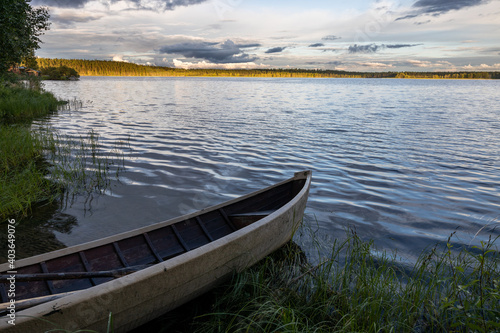 Old rowing boat at the lake with forest landscape in background under cloudy sky, Kuusamo.,Lapland, Finland © sg-naturephoto.com 